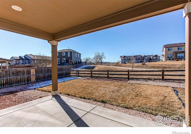 view of patio with a residential view and a fenced backyard