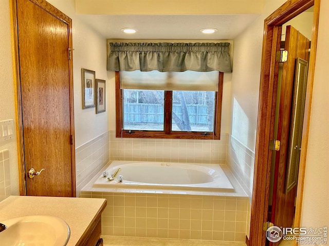 full bath with a garden tub and vanity