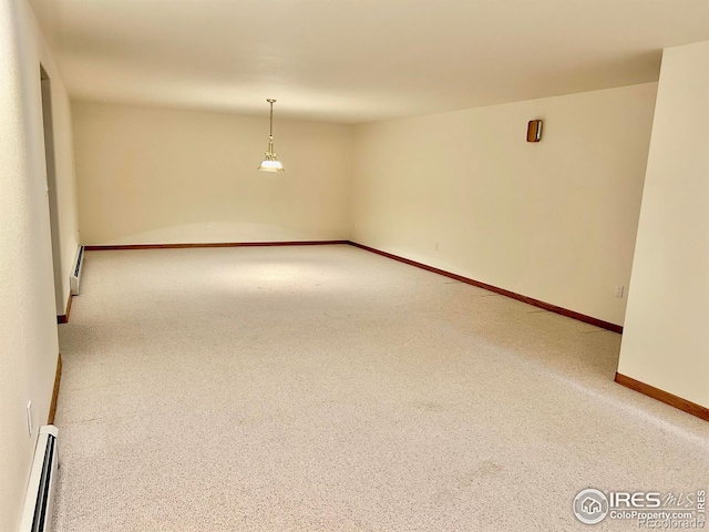 unfurnished room with carpet floors, a baseboard radiator, and baseboards