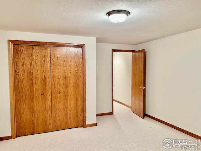 unfurnished bedroom featuring carpet flooring and baseboards