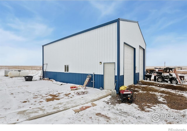 snow covered structure featuring an outdoor structure