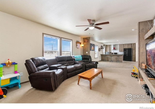 living room featuring light carpet and a ceiling fan