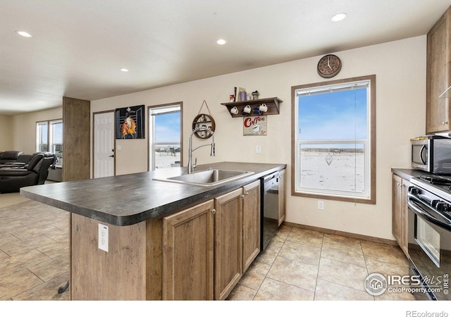 kitchen featuring black range with gas cooktop, a sink, dishwasher, stainless steel microwave, and dark countertops