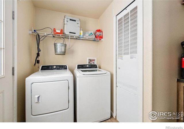 clothes washing area with independent washer and dryer