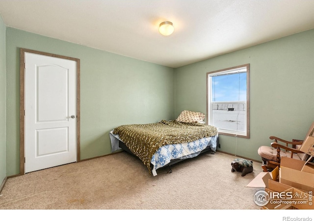 bedroom featuring carpet floors and baseboards