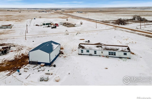 snowy aerial view featuring a rural view