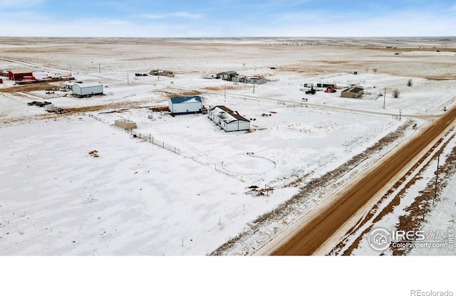 snowy aerial view featuring a rural view