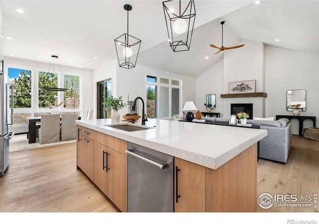 6398 Foundry Ct, Timnath, CO 80547 - kitchen featuring a sink, stainless steel appliances, plenty of natural light, light countertops, and high vaulted ceiling