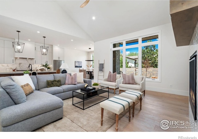 6398 Foundry Ct, Timnath, CO 80547 - living area with light wood finished floors, high vaulted ceiling, recessed lighting, and baseboards