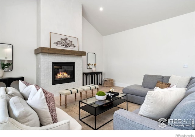 6398 Foundry Ct, Timnath, CO 80547 - living area featuring high vaulted ceiling, wood finished floors, a fireplace, recessed lighting, and baseboards