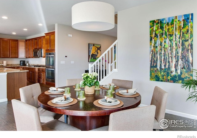 dining area with baseboards, dark wood finished floors, and recessed lighting