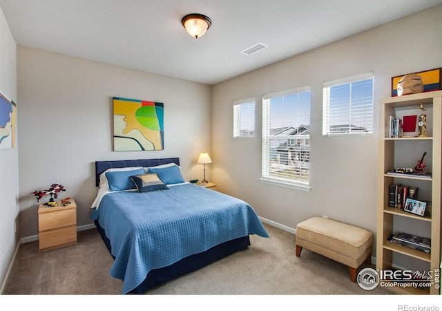 bedroom with carpet, visible vents, and baseboards