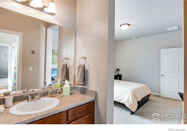 bathroom featuring visible vents, connected bathroom, and vanity