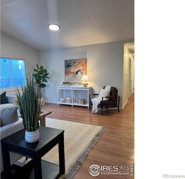 living room with wood finished floors and baseboards