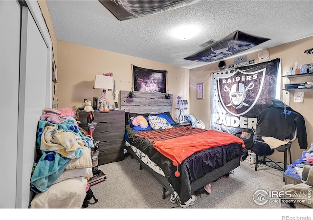 carpeted bedroom with a textured ceiling