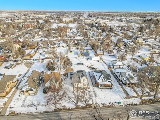 snowy aerial view featuring a residential view