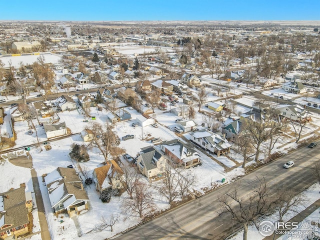 snowy aerial view with a residential view