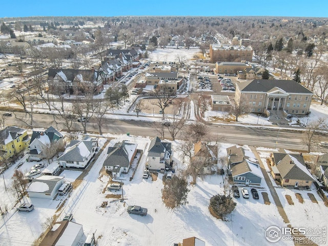 snowy aerial view with a residential view