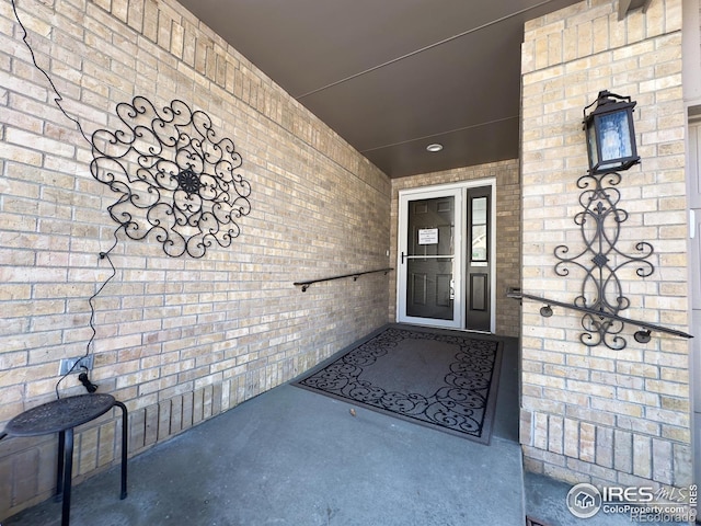 entrance to property with brick siding