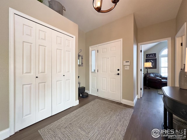 entryway featuring baseboards and dark wood-style flooring