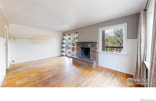 unfurnished living room featuring a fireplace and light wood finished floors