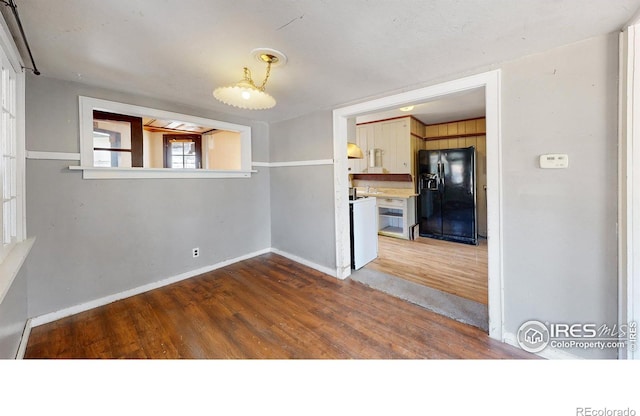 interior space featuring dark wood-type flooring and baseboards