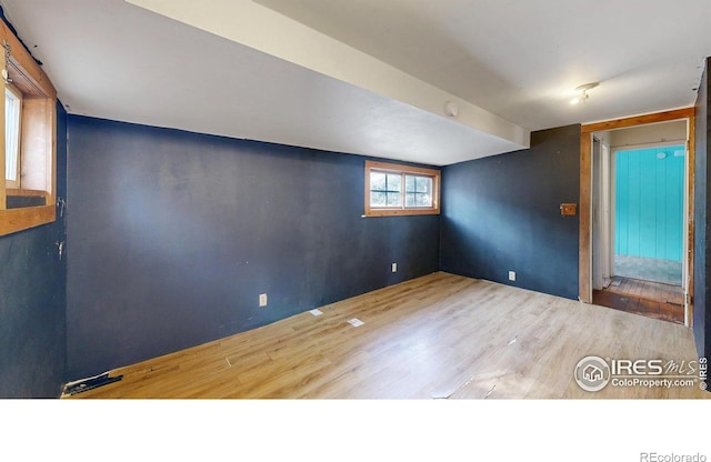 spare room featuring wood finished floors