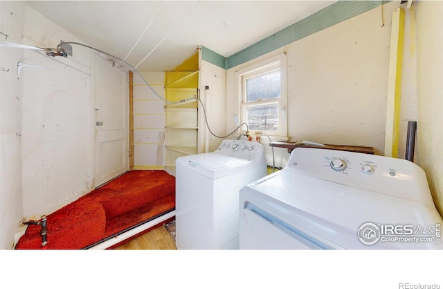 clothes washing area with independent washer and dryer