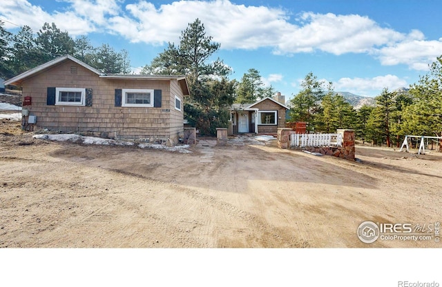 rustic home featuring driveway