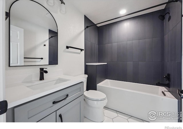 full bath with tile patterned flooring, toilet, vanity, and shower / tub combination