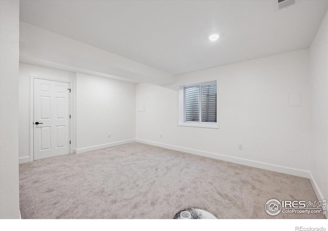 unfurnished room with light colored carpet, visible vents, and baseboards