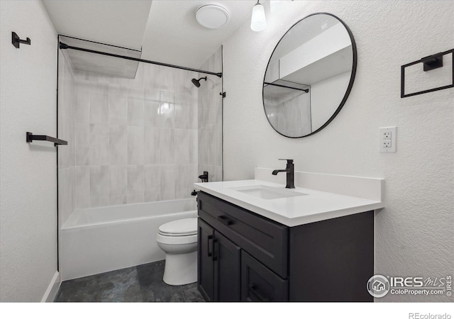 full bath featuring bathtub / shower combination, a textured wall, vanity, and toilet