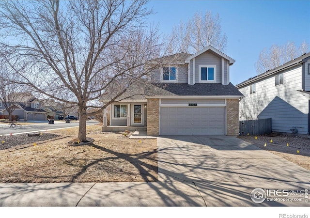 traditional home featuring a garage, concrete driveway, brick siding, and a shingled roof