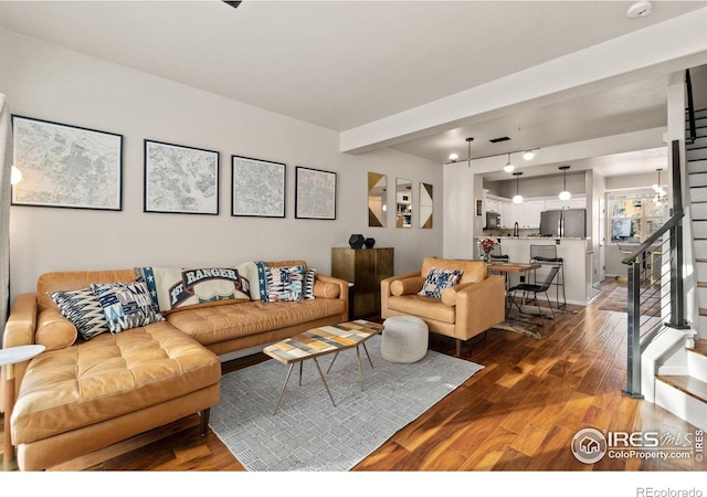 living room with stairway and dark wood-type flooring