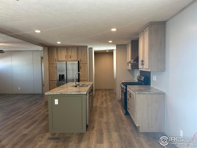 kitchen featuring stainless steel appliances, dark wood-style flooring, a sink, and wall chimney exhaust hood