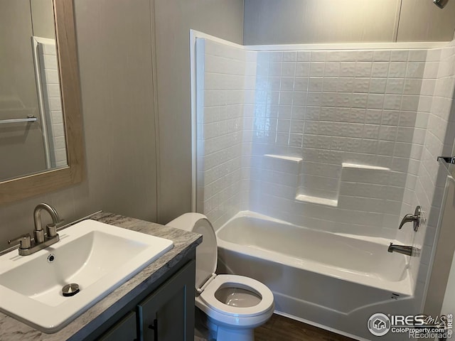 full bathroom with toilet, tub / shower combination, wood finished floors, and vanity