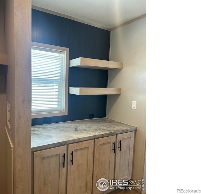 kitchen featuring crown molding and open shelves