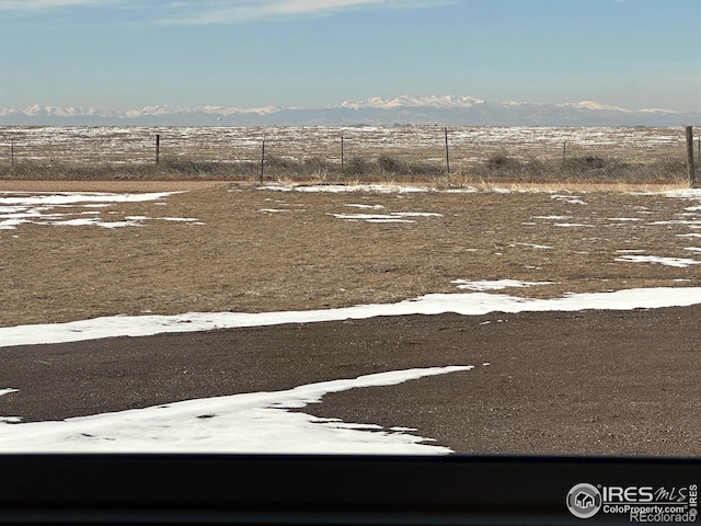 view of yard featuring fence and a mountain view