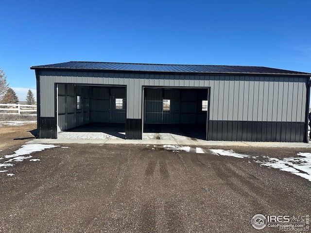 detached garage featuring fence