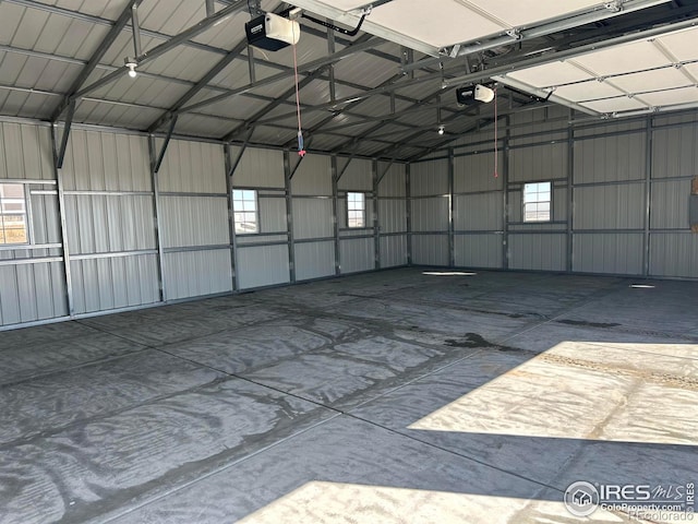 garage with metal wall and a garage door opener