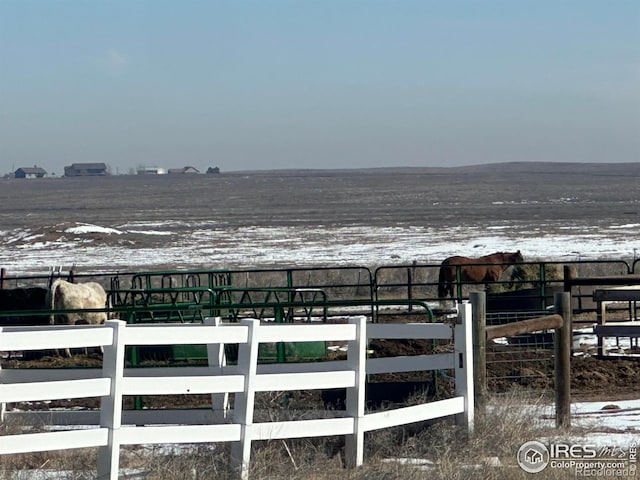 view of horse barn with a rural view