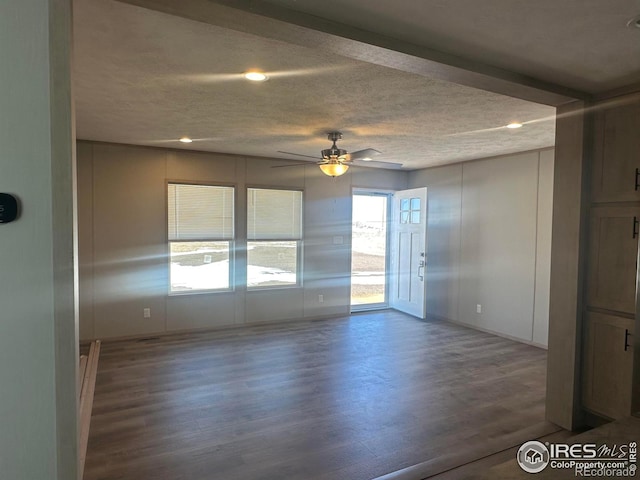 unfurnished room with a textured ceiling, wood finished floors, a ceiling fan, and recessed lighting