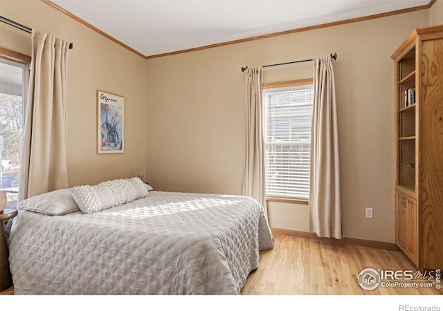 bedroom with light wood-type flooring and crown molding