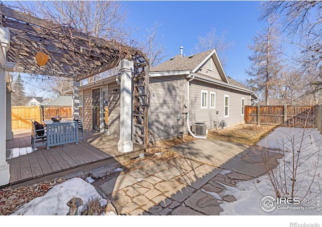 back of property with a patio area, central AC, a pergola, a fenced backyard, and a wooden deck