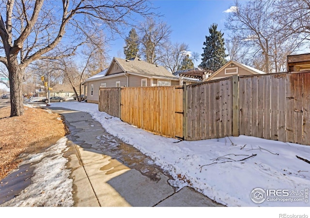 view of snowy exterior featuring fence