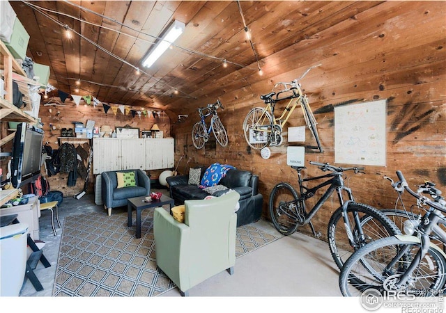 living room with concrete floors, wood ceiling, and wooden walls