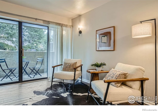 living area featuring wood finished floors and baseboards