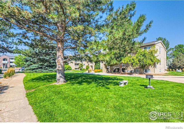 obstructed view of property with a front lawn