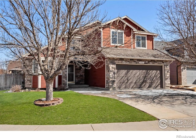 craftsman-style house with an attached garage, fence, stone siding, driveway, and a front lawn