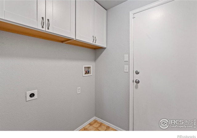 clothes washing area with cabinet space, hookup for a washing machine, baseboards, and hookup for an electric dryer